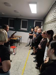 Zdjęcie zbiorowe uczniów w trakcie instruktażu na strzelnicy.
