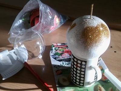 Kubek na którym położona jest ozdabiana bombka.