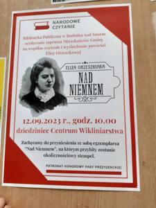 Zdjęcie przedstawia plakat informujący o wydarzeniu - Narodowe Czytanie, organizowanym przez Bibliotekę Publiczną w Rudniku nad Sanem. 