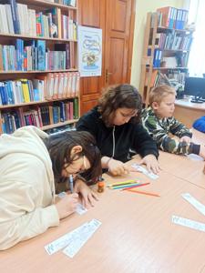 Dziewczyny wykonują zakładki do książek.