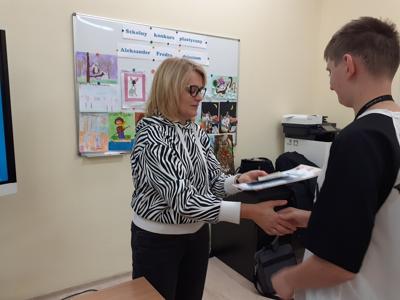 Pani Ania Sz. wręcza dyplom Kacprowi.