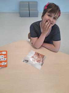  Kornelia układa puzzle z instrukcją mycia dłoni.