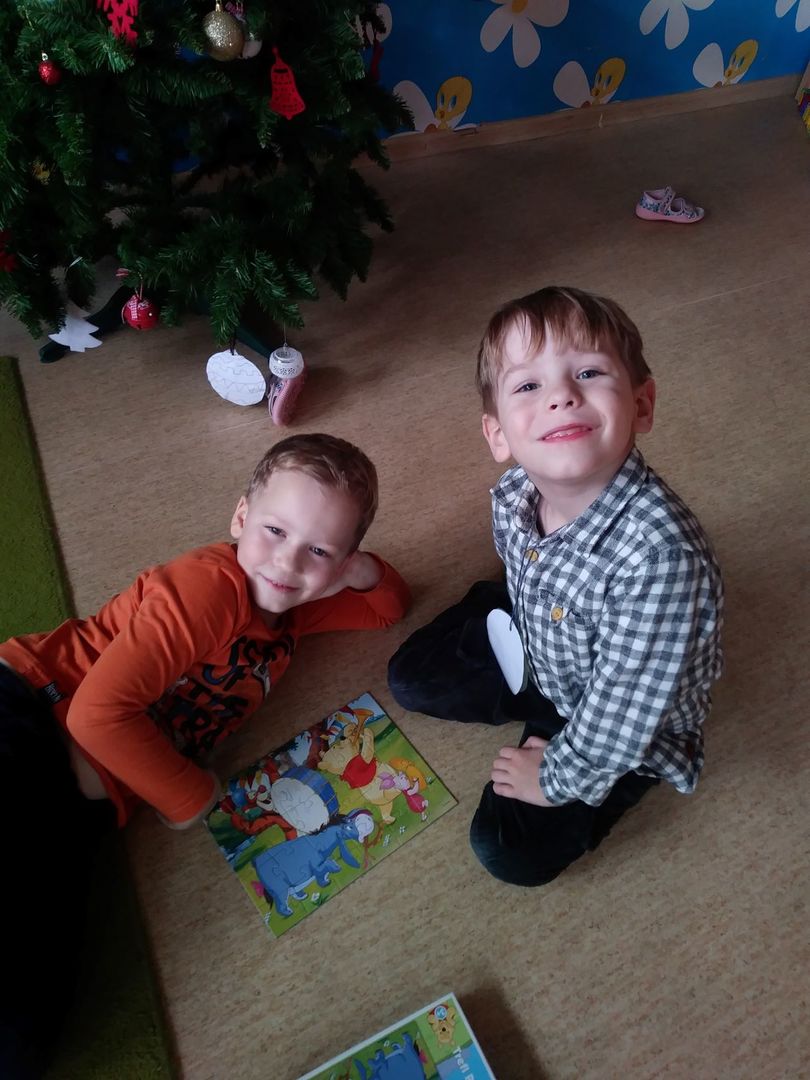 Zdjęcie przedstawia uśmiechniętych Mateusza i Franka z ułożonymi puzzlami.