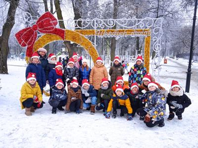 Dzieci z klasy 2a na zdjęciu grupowym w zimowej scenerii 