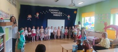 Grupa dzieci stojąca w półkole na tle napisu Gminny Konkurs Wiedzy