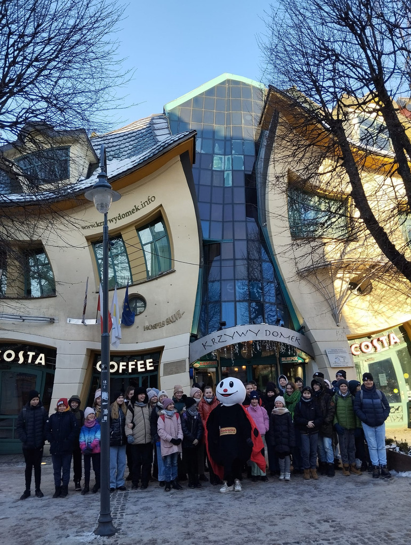 Grupa Uczniów na tle Krzywego Domku w Sopocie.