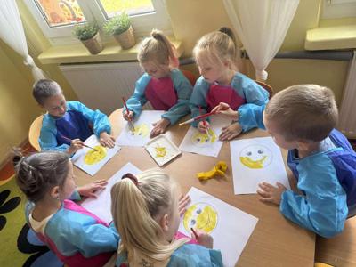 Dzieci wykonują pracę plastyczną farbami