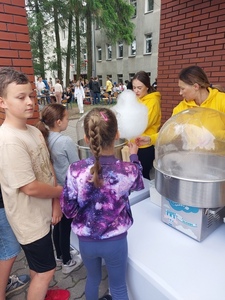 Grupa uczniów oczekujących przed automatem na watę cukrową.